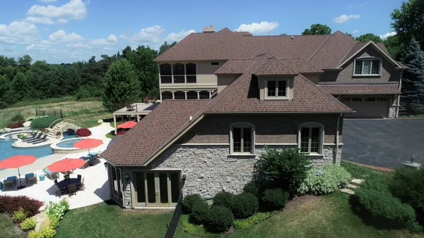 a aerial view of a house with swimming pool and garden