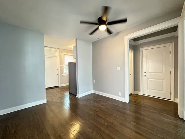 a view of an empty room and wooden floor