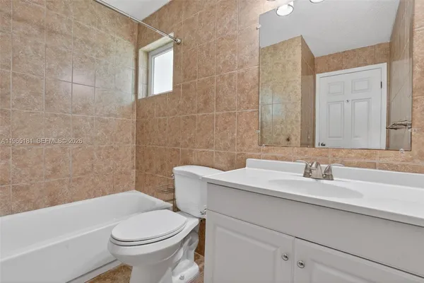 a bathroom with a sink a toilet and bathtub