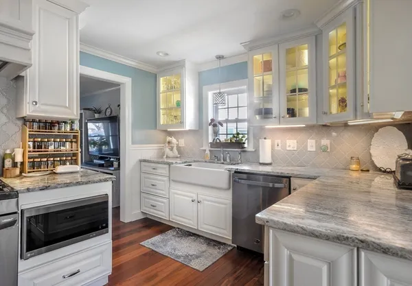 a kitchen with a stove a sink and a refrigerator