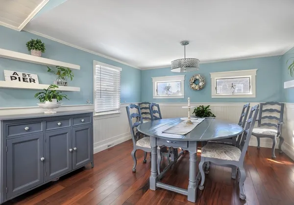 a view of a dining room with furniture and wooden floor