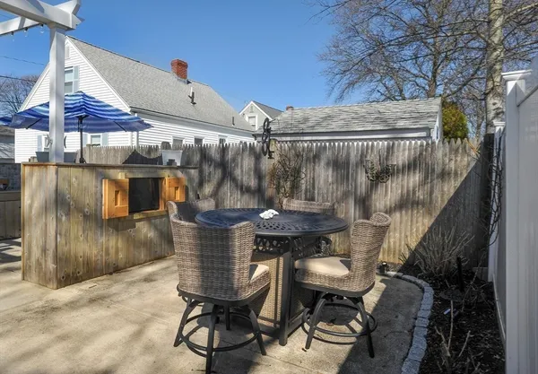a view of a chair and tables in the patio