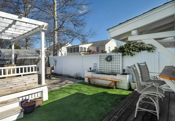 a table and chairs sitting in backyard of a house