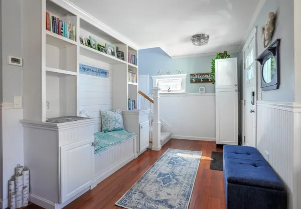 a view of an entryway with wooden floor and a rug
