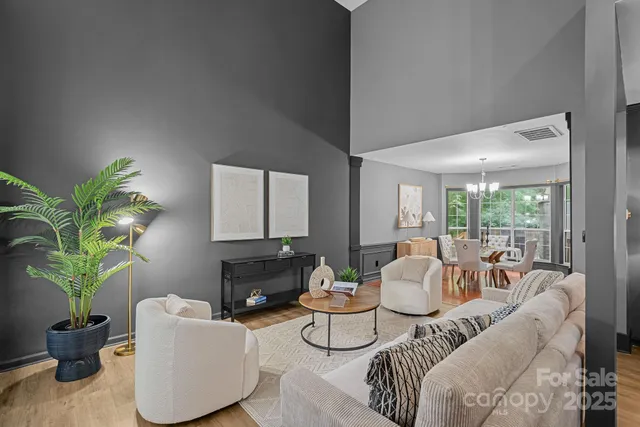 a living room with furniture a fireplace and a potted plant