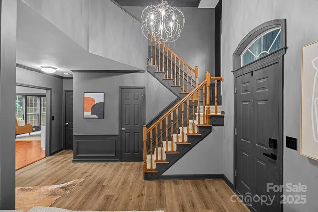 a view of entryway and hall with wooden floor