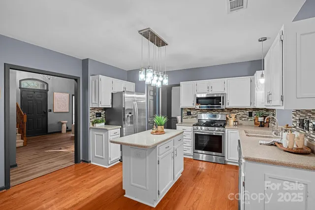 a kitchen with a sink stove and refrigerator