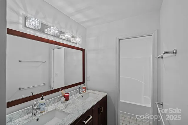 a bathroom with a sink vanity and a mirror