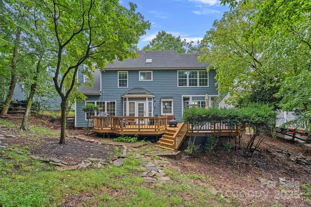a front view of a house with yard and green space