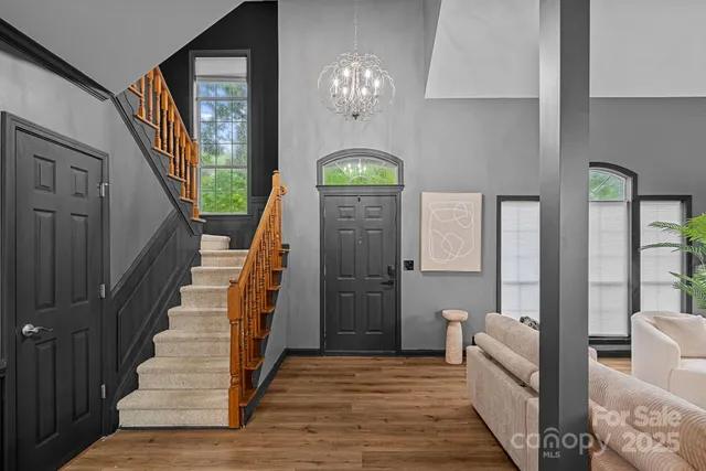 a view of an entryway with wooden floor and a chandelier