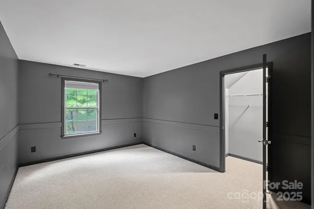 a view of a big room with windows and closet