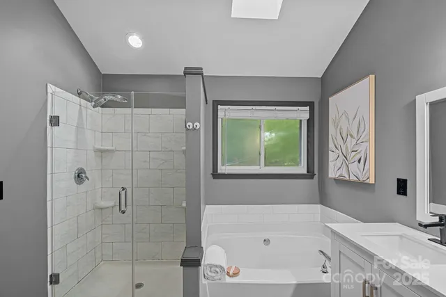 a bathroom with a bathtub and a shower