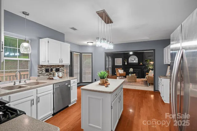 a large white kitchen with a large window