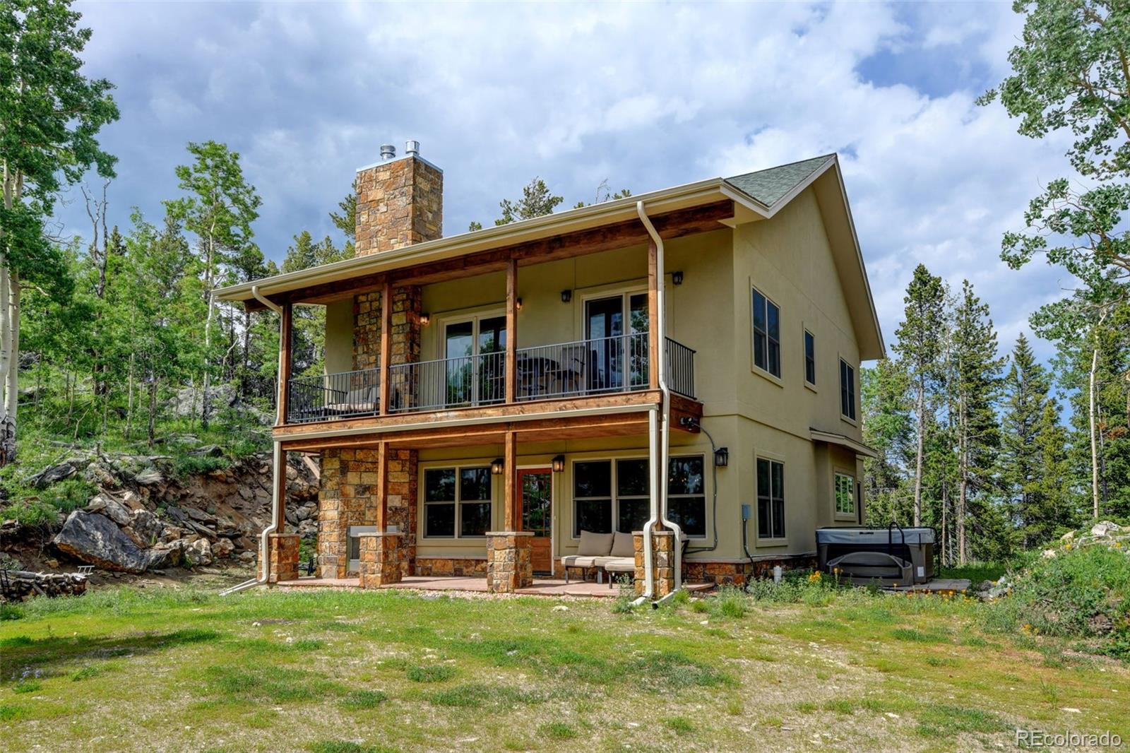 1555 Three Peaks Road Black Hawk, CO 80422 - Photo 1 of 50 a house that has a big yard in front of it