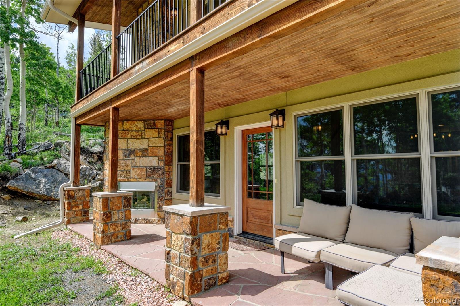 1555 Three Peaks Road Black Hawk, CO 80422 - Photo 14 of 50 a view of a patio with a dining table and chairs