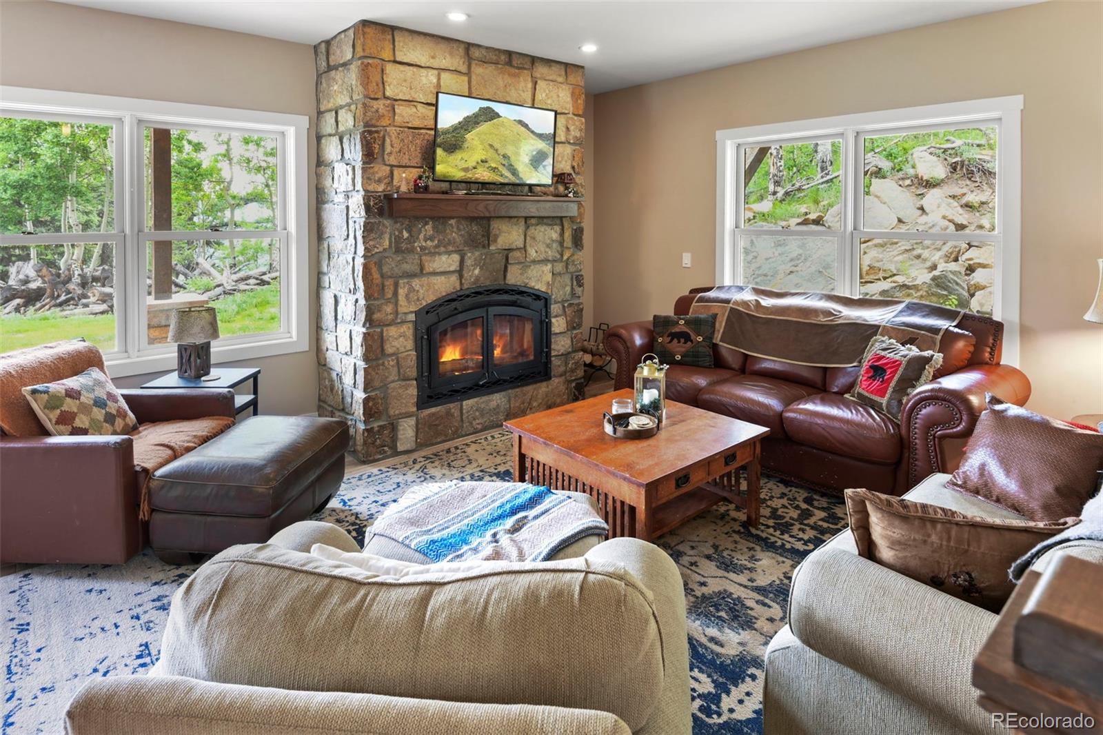 1555 Three Peaks Road Black Hawk, CO 80422 - Photo 17 of 50 a living room with furniture and a fireplace