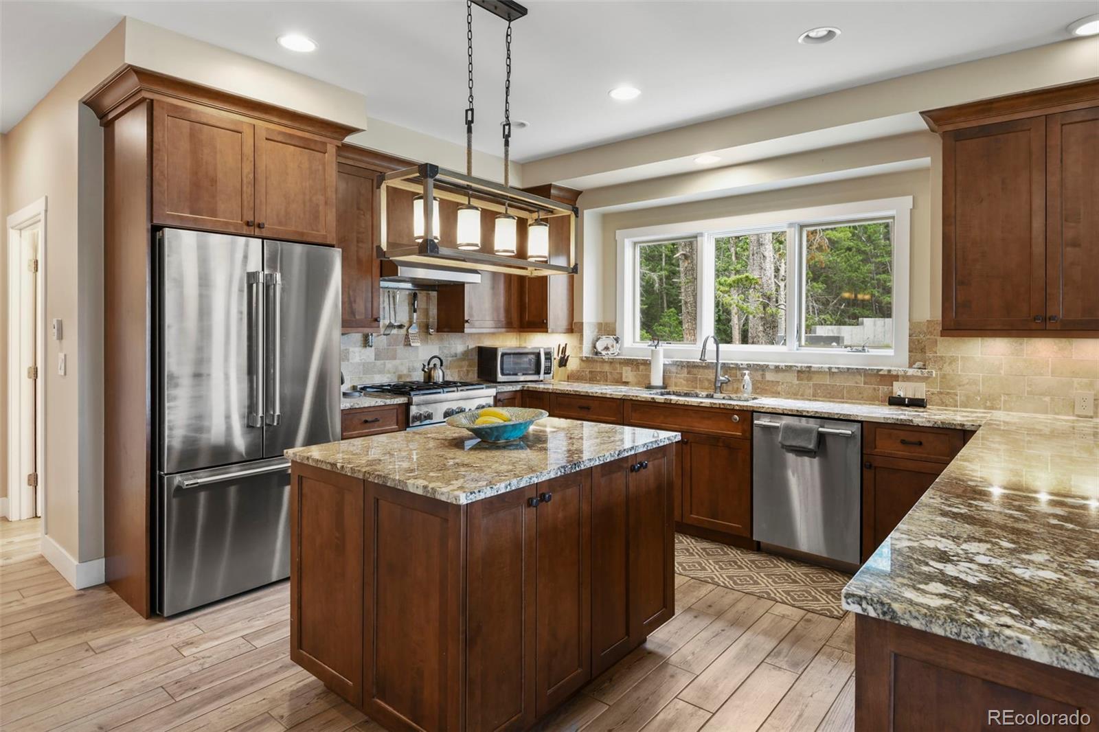 1555 Three Peaks Road Black Hawk, CO 80422 - Photo 23 of 50 a kitchen with stainless steel appliances granite countertop a refrigerator a sink dishwasher a stove and a refrigerator