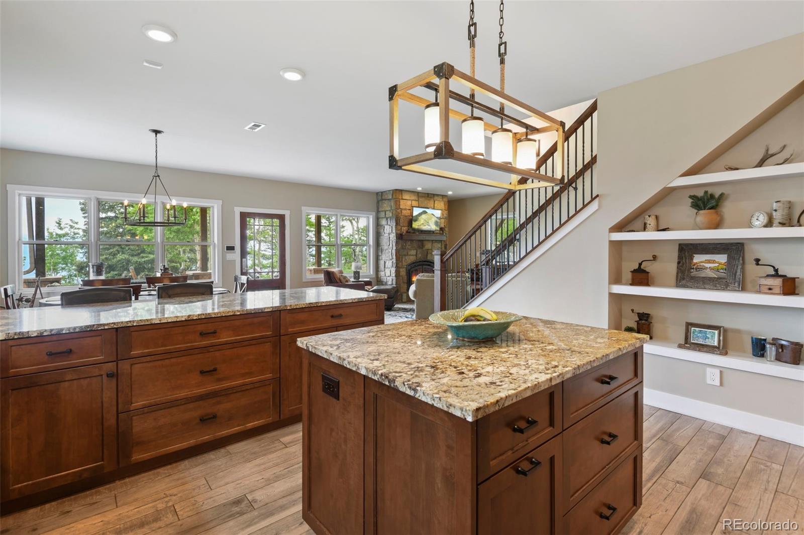 1555 Three Peaks Road Black Hawk, CO 80422 - Photo 25 of 50 a kitchen with a stove a sink and a wooden floors