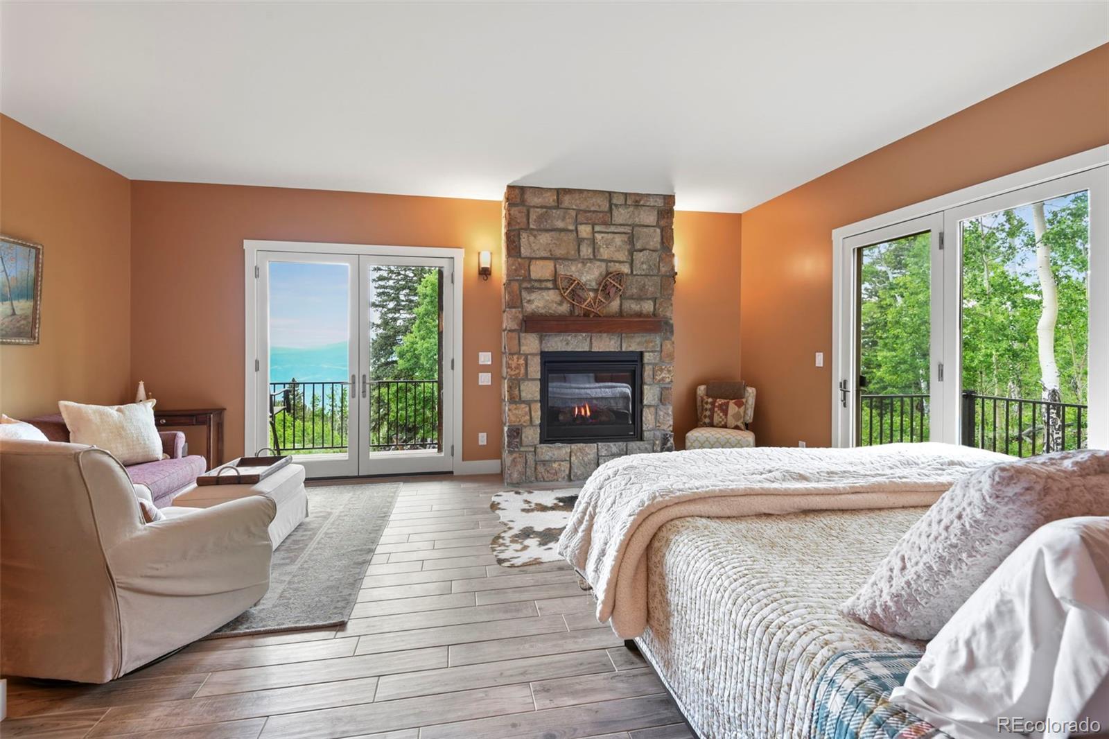 1555 Three Peaks Road Black Hawk, CO 80422 - Photo 38 of 50 a spacious bedroom with a bed and a large window