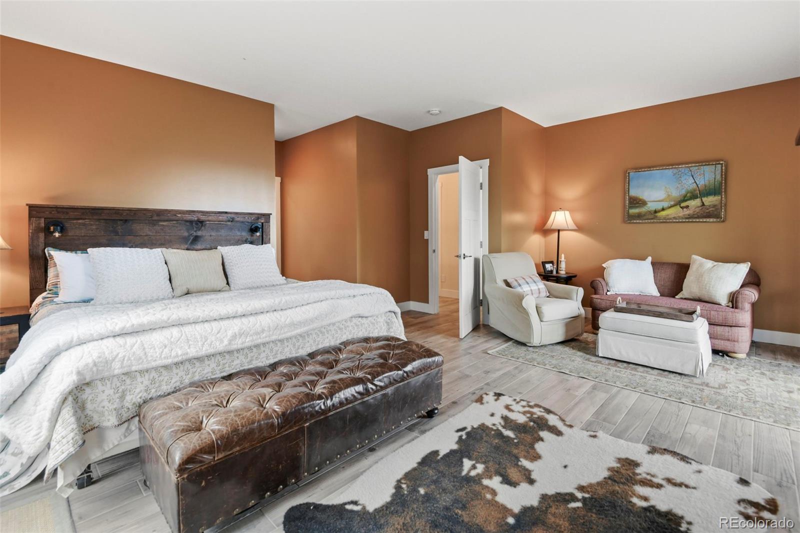1555 Three Peaks Road Black Hawk, CO 80422 - Photo 39 of 50 a bedroom with bed and lamp