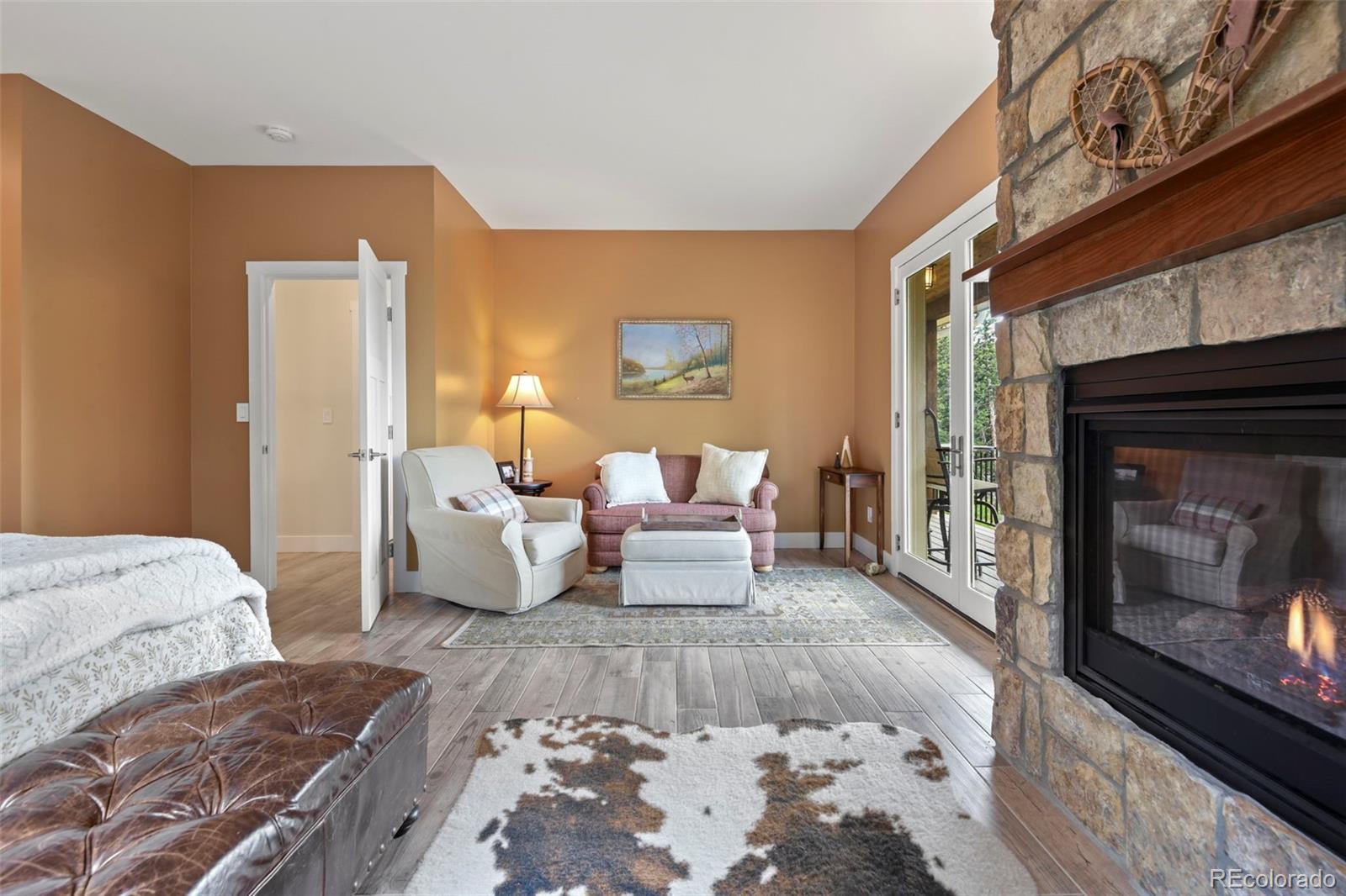 1555 Three Peaks Road Black Hawk, CO 80422 - Photo 40 of 50 a bedroom with bed and a fireplace
