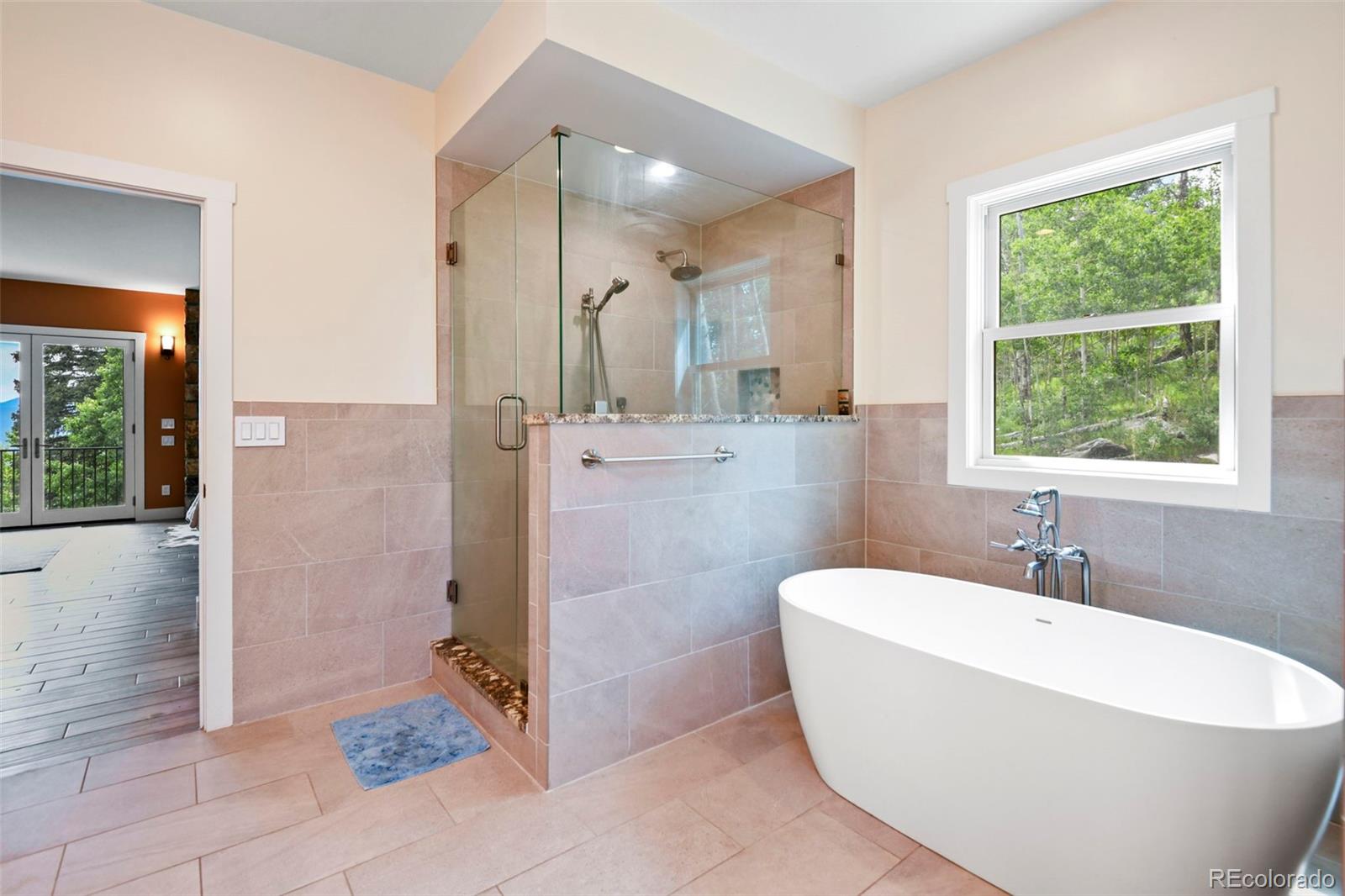 1555 Three Peaks Road Black Hawk, CO 80422 - Photo 45 of 50 a spacious bathroom with a bathtub and a shower