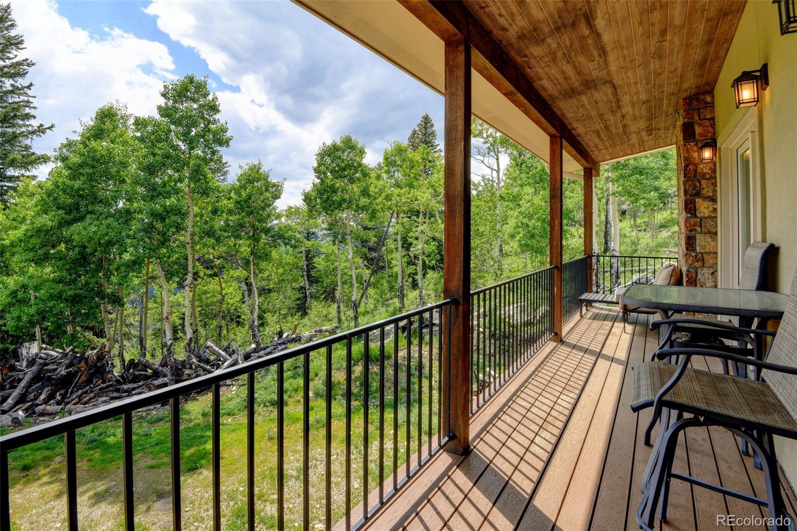 1555 Three Peaks Road Black Hawk, CO 80422 - Photo 46 of 50 a view of balcony with chairs and wooden fence
