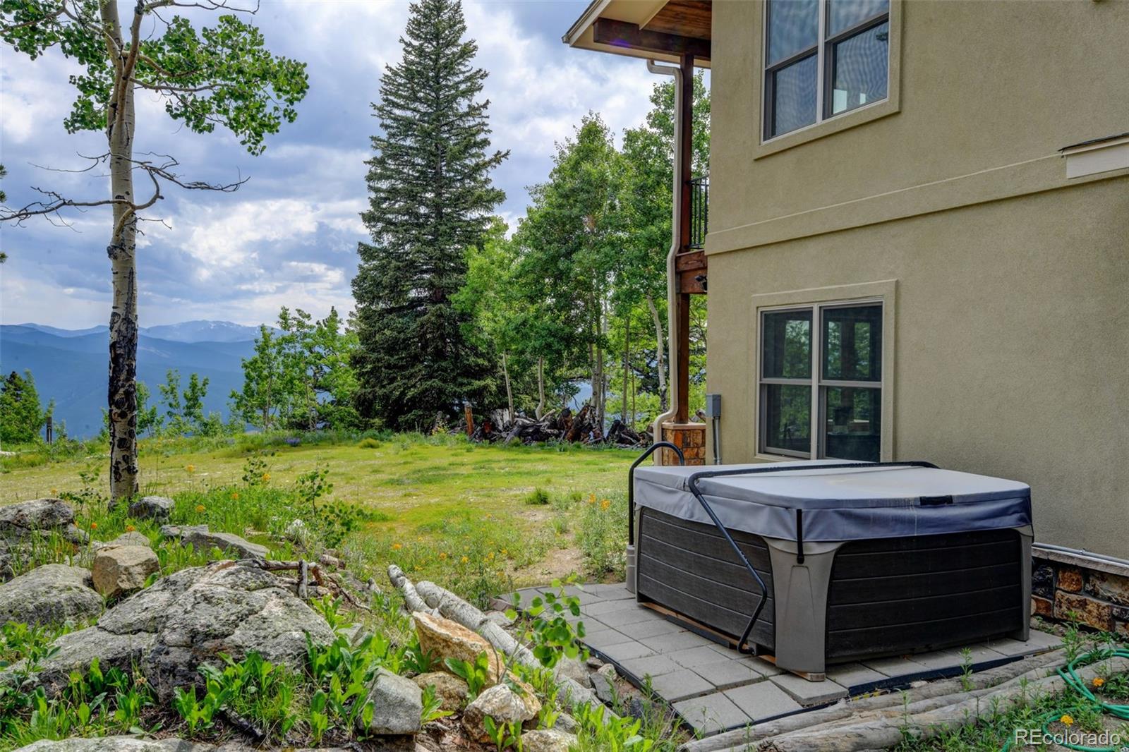 1555 Three Peaks Road Black Hawk, CO 80422 - Photo 48 of 50 a view of a backyard with plants and a garden