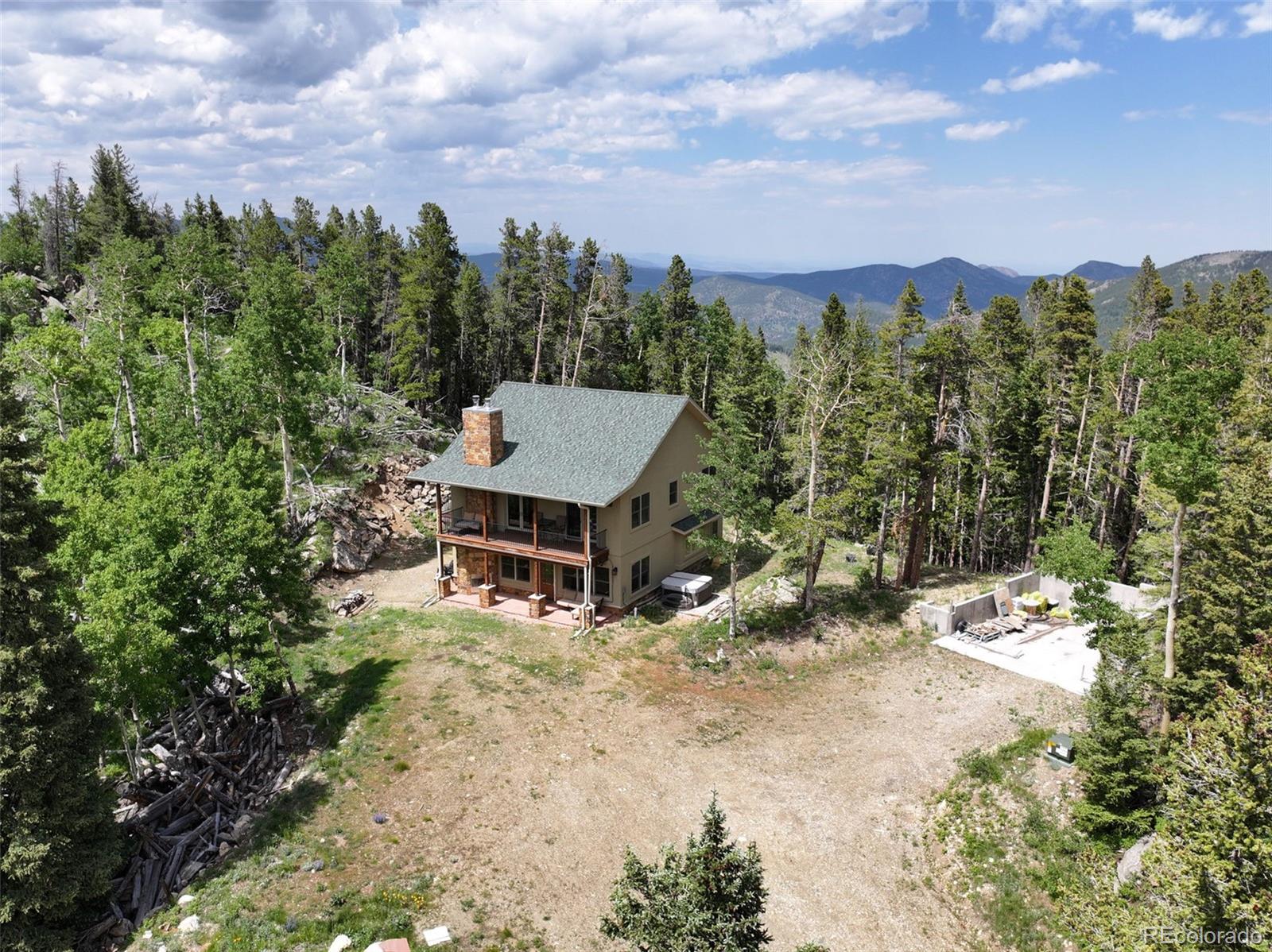 1555 Three Peaks Road Black Hawk, CO 80422 - Photo 5 of 50 a view of a terrace with a garden and trees