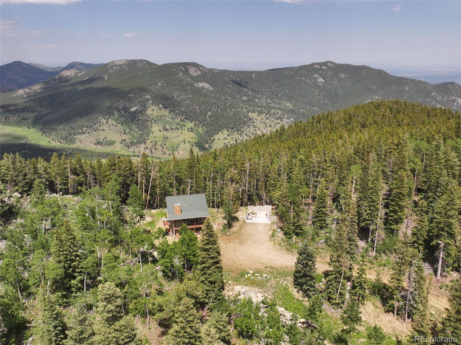 1555 Three Peaks Road Black Hawk, CO 80422 - Photo 9 of 50 a view of a city with mountains in the background