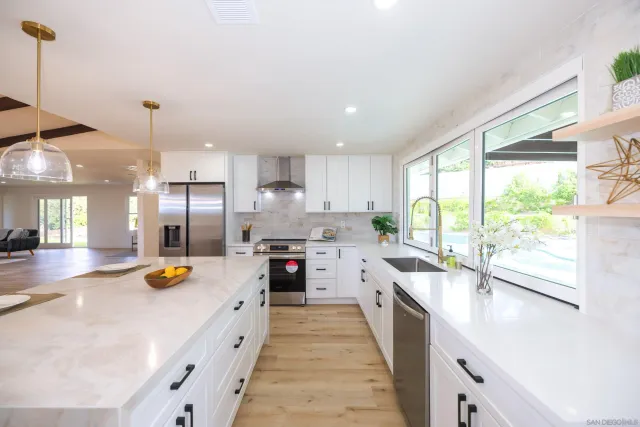 a kitchen with a sink a counter and chairs