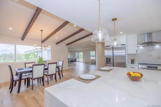 a view of a dining room with furniture and a chandelier
