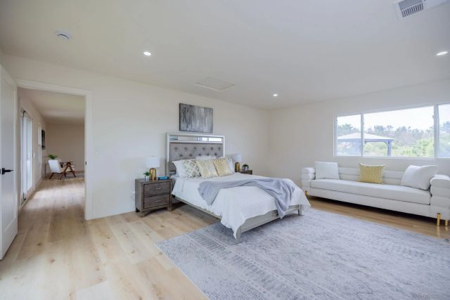 a bedroom with furniture and a large window