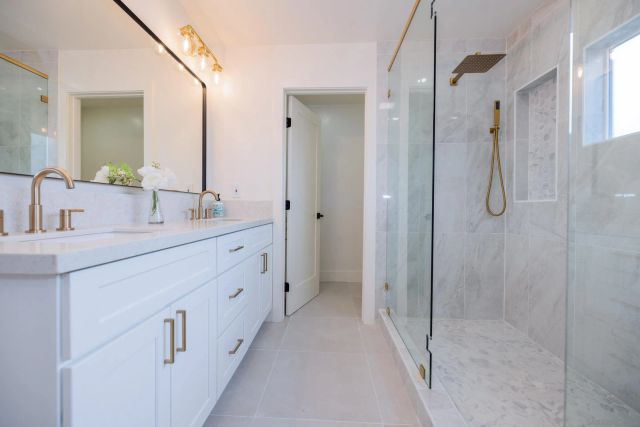 a bathroom with a sink double vanity and a mirror