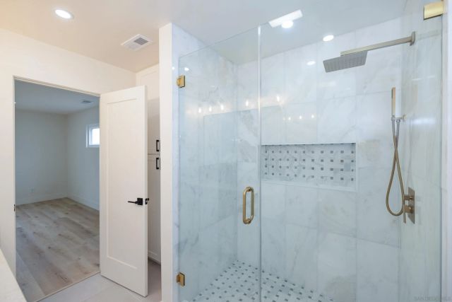 a bathroom with a double vanity sink and a mirror