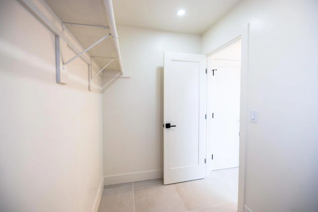 a bathroom with a granite countertop sink a toilet and shower