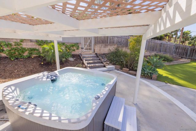 a room with stainless steel appliances wooden floor and window
