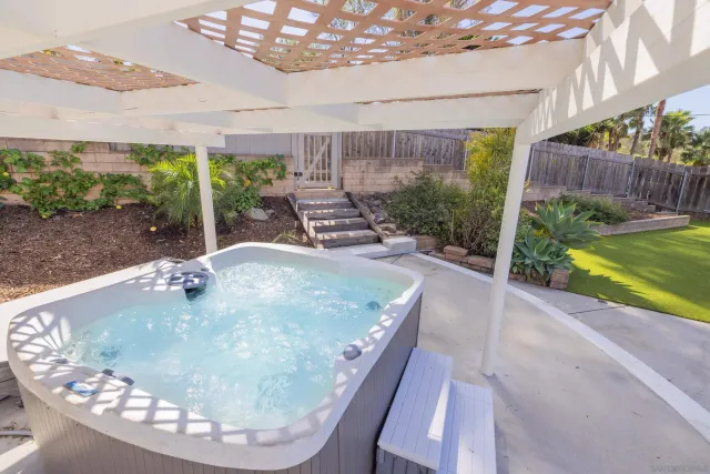 a room with stainless steel appliances wooden floor and window