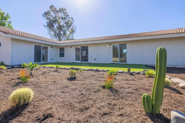 a view of a house with a yard and garage