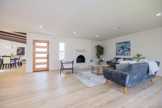 a dining room with furniture and wooden floor