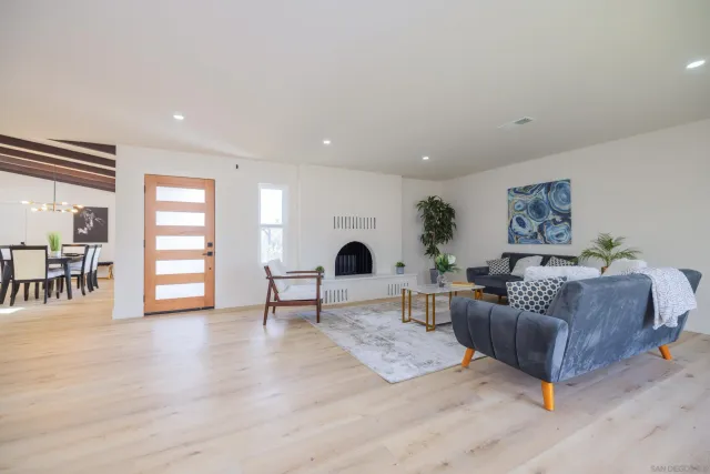 a dining room with furniture and wooden floor