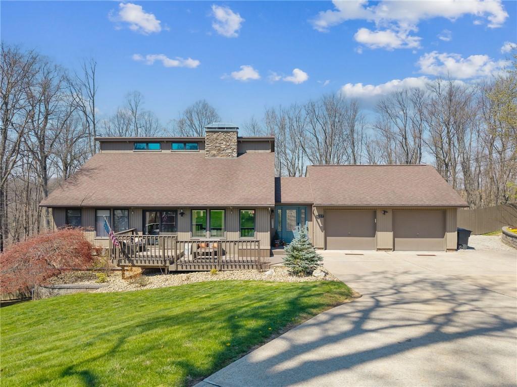 a front view of a house with garden and patio