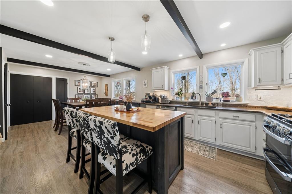 2187 Elizabeth Court Export, PA 15632 - Photo 12 of 43 a kitchen with stainless steel appliances granite countertop a table chairs sink and cabinets