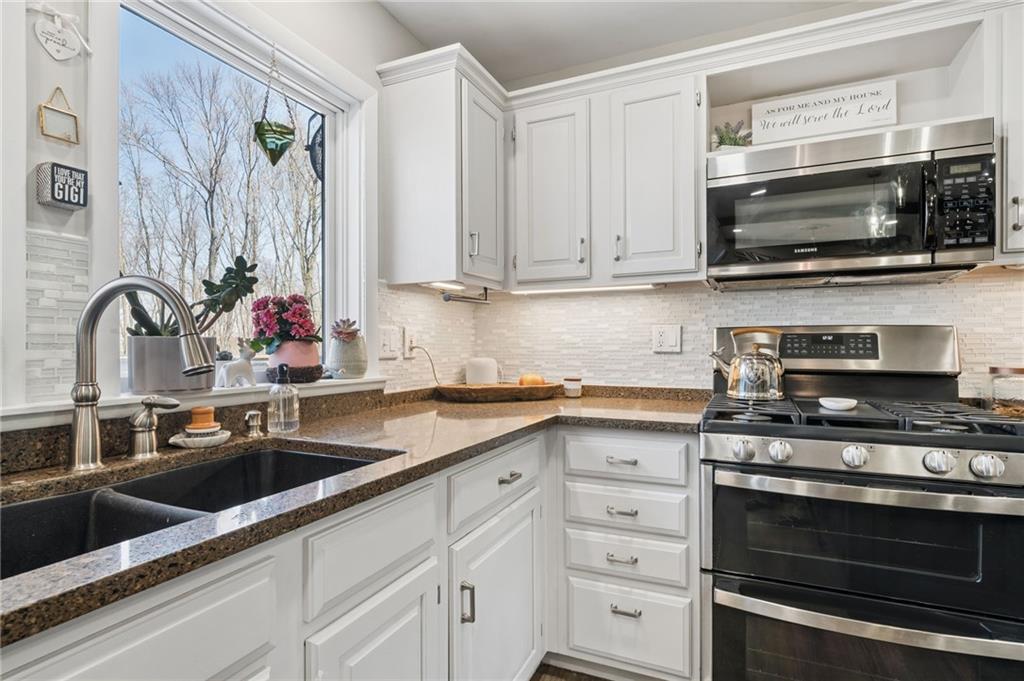 2187 Elizabeth Court Export, PA 15632 - Photo 14 of 43 a kitchen with stainless steel appliances a stove microwave and sink