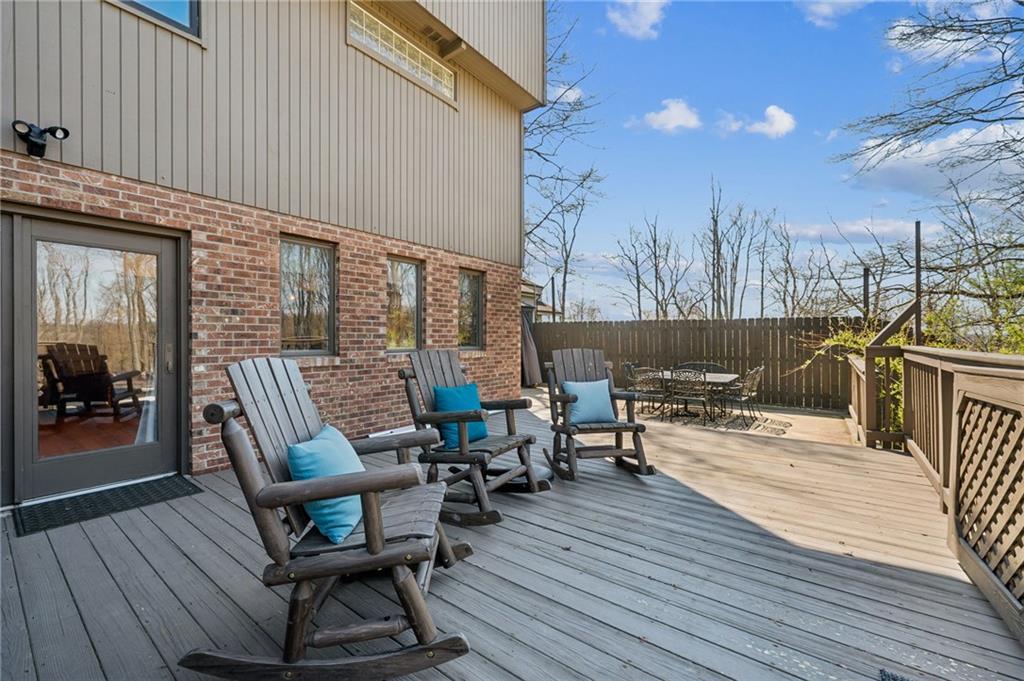 2187 Elizabeth Court Export, PA 15632 - Photo 33 of 43 a view of a patio with dining table and chairs with wooden floor and fence