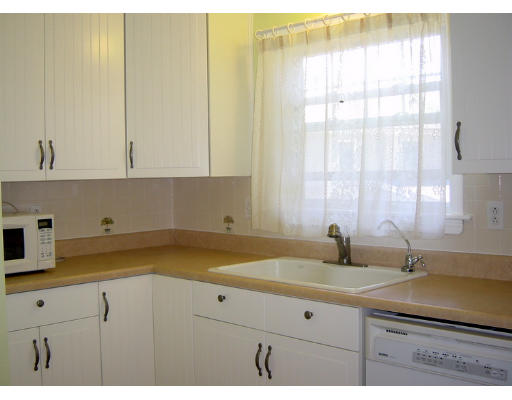 4 Douglas Road Belmont, MA 02478 - Photo 5 of 9 a view of a kitchen with a sink a window and cabinets