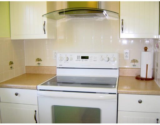 4 Douglas Road Belmont, MA 02478 - Photo 6 of 9 a kitchen with a stove and white cabinets