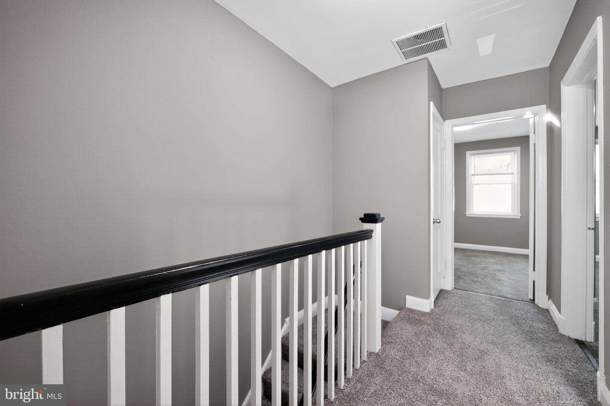 901 Kevin Road Baltimore, MD 21229 - Photo 12 of 31 a view of a hallway with wooden floor and stairs