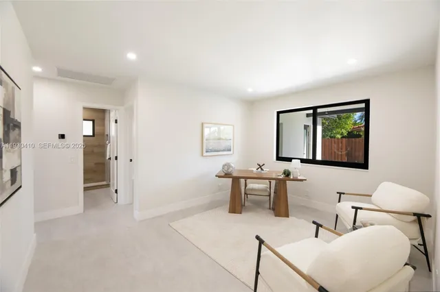 a living room with furniture windows and a table
