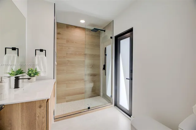 a bathroom with a shower and a sink